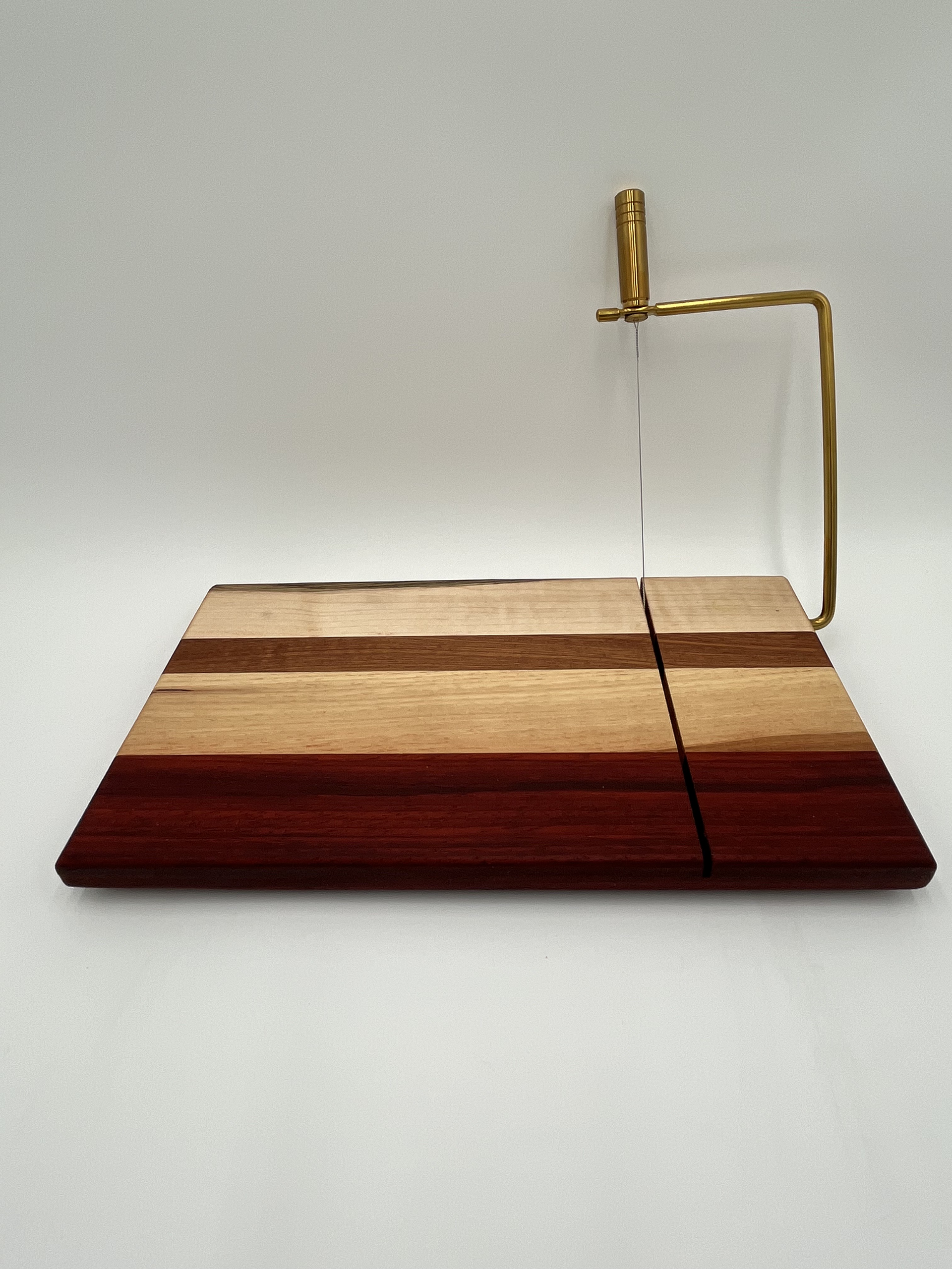 A wooden cutting board with a cutting tool on it