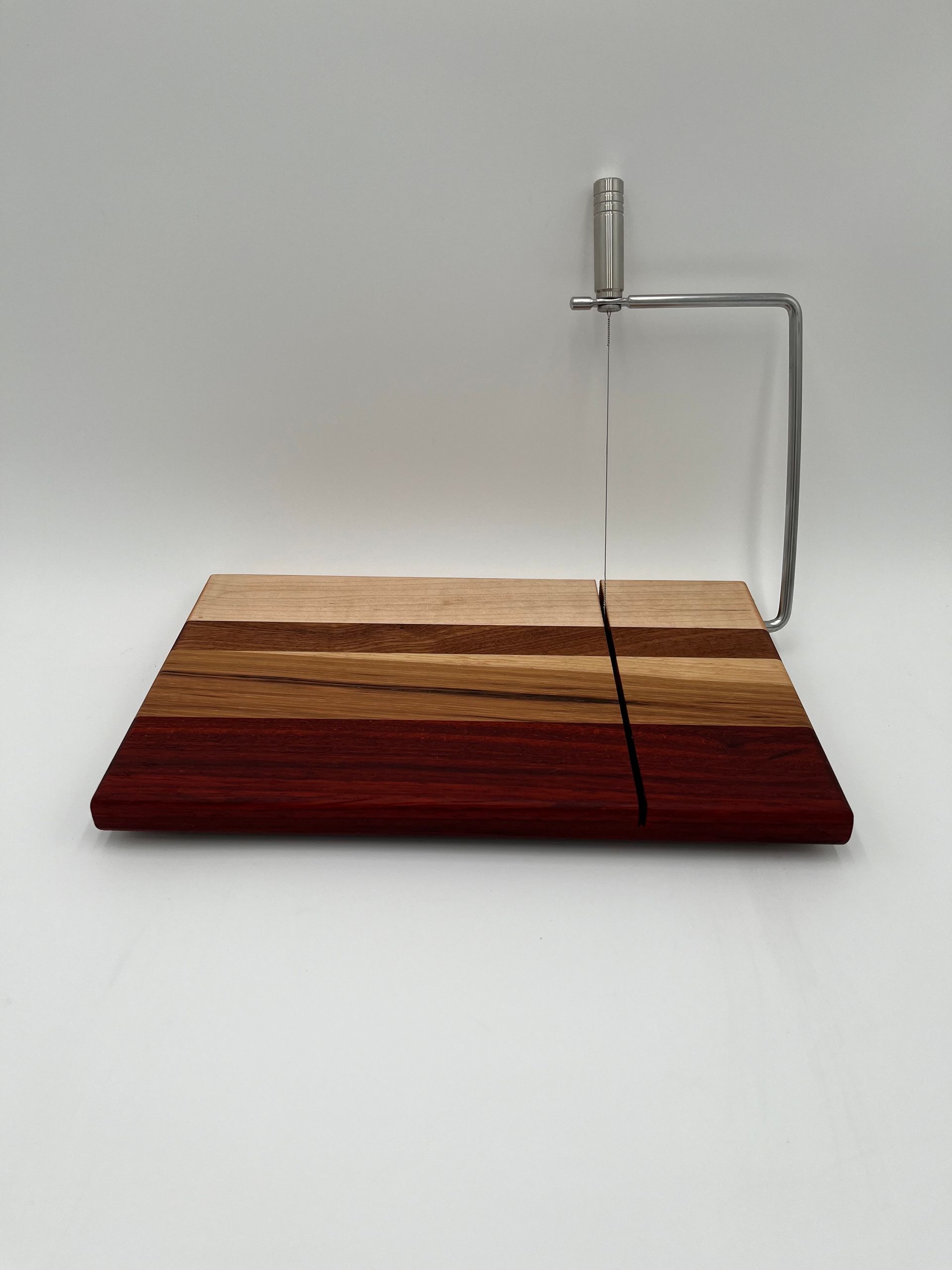 A wooden cutting board with a cutting machine on it.