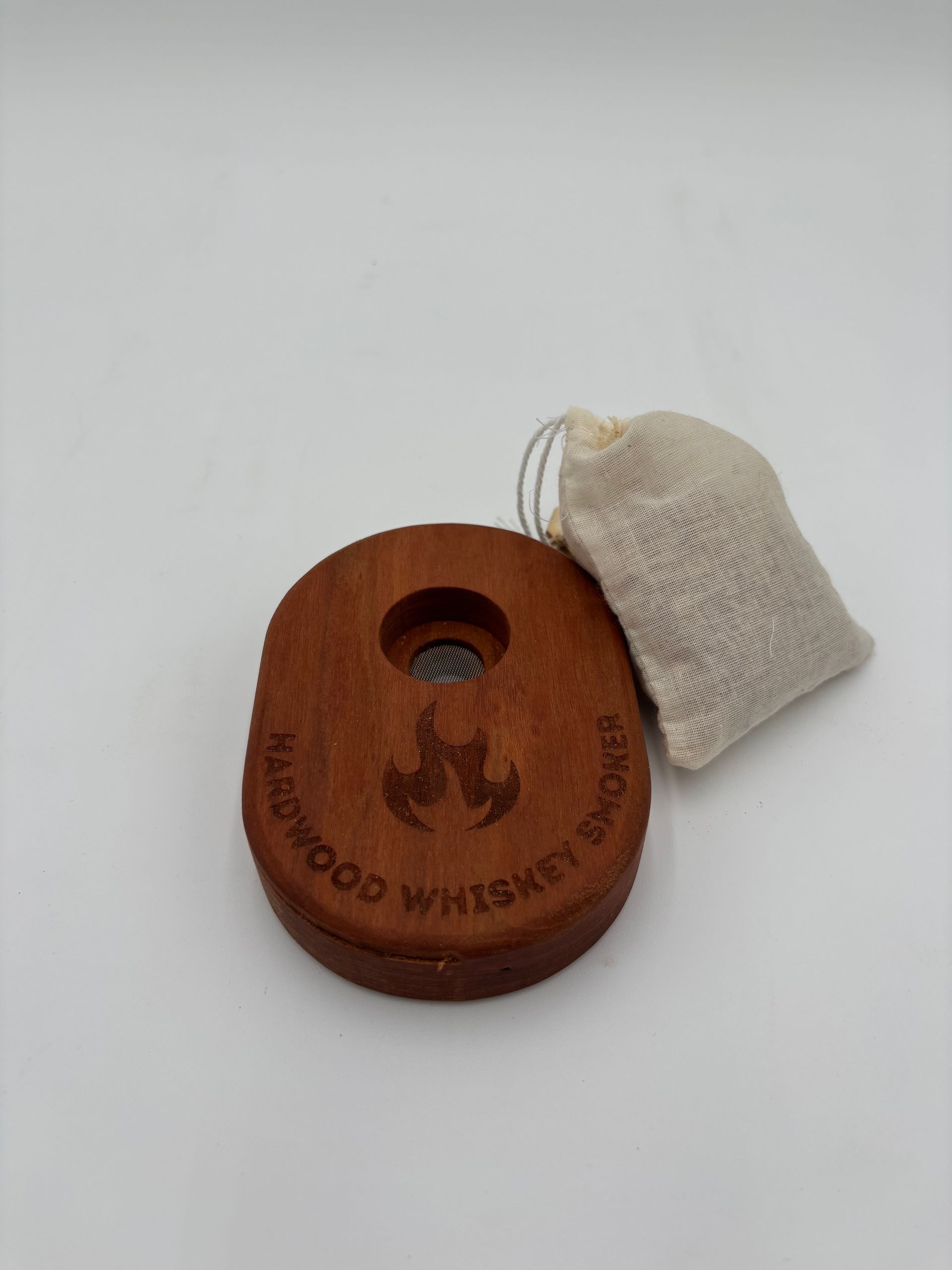Wooden whiskey smoker with a small bag of wood chips.