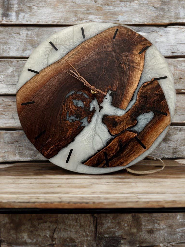 Wooden clock with brown wood, white resin, and black hands against a wood background
