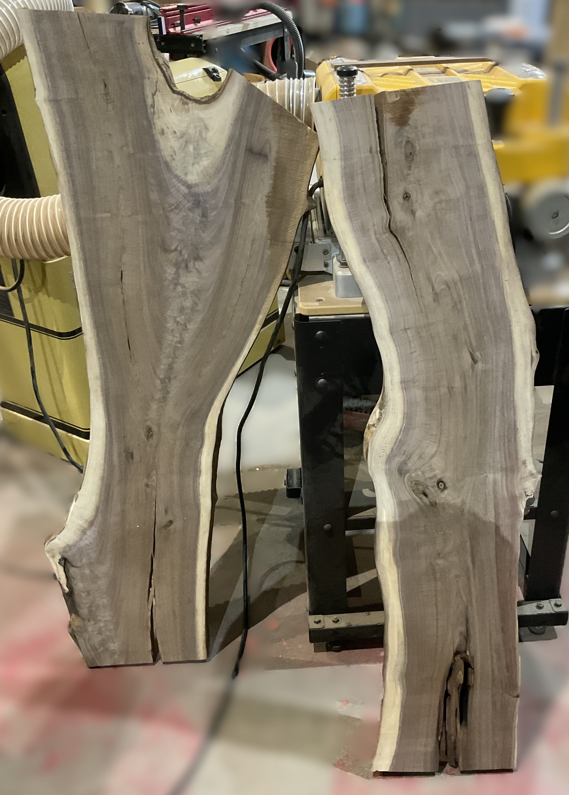 Two pieces wood are sitting next to each other on a table.