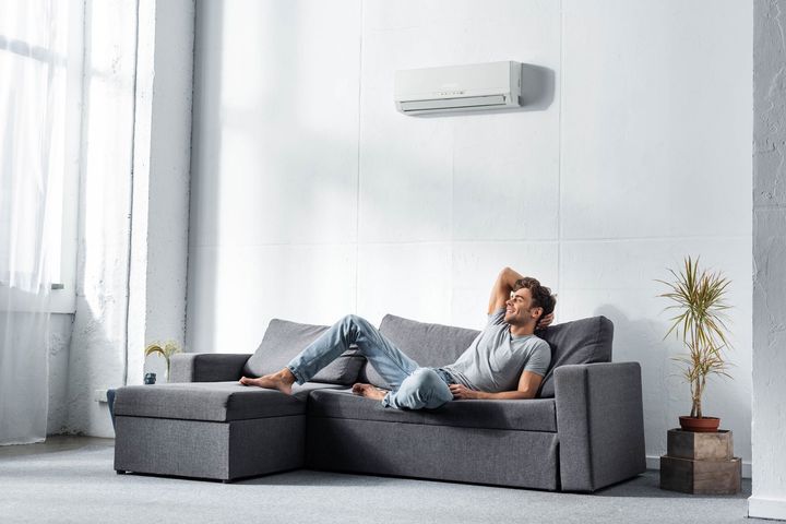 Man lying on the sofa — Brisbane, CA — Eagle Refrigeration Heating & AC Inc.
