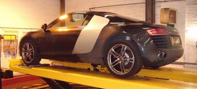 luxury sports car on inspection ramp