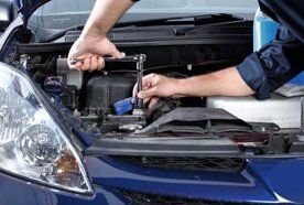 using a specialist wrench on a car engine