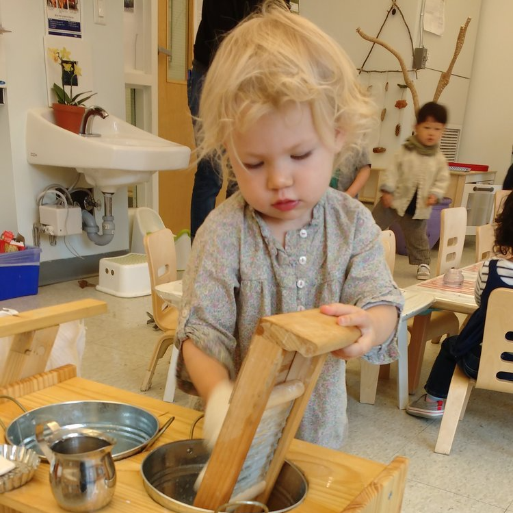 Montessori toddler working on practical life skills