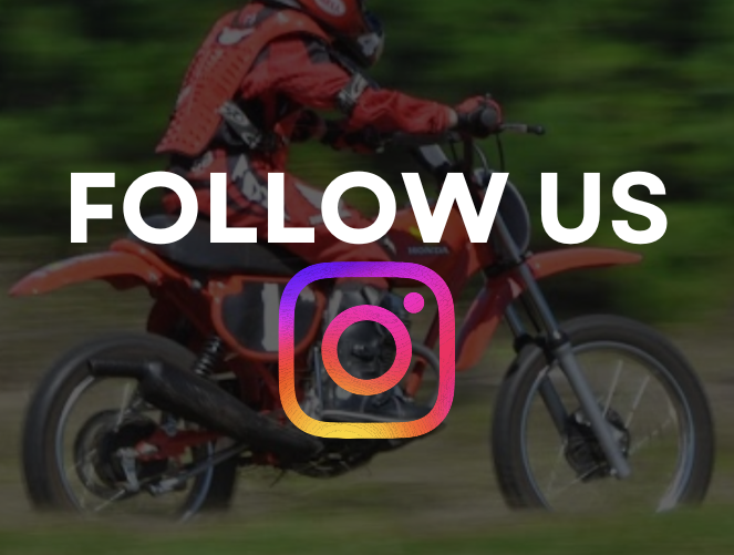 Motorcyclist on an orange dirt bike with 