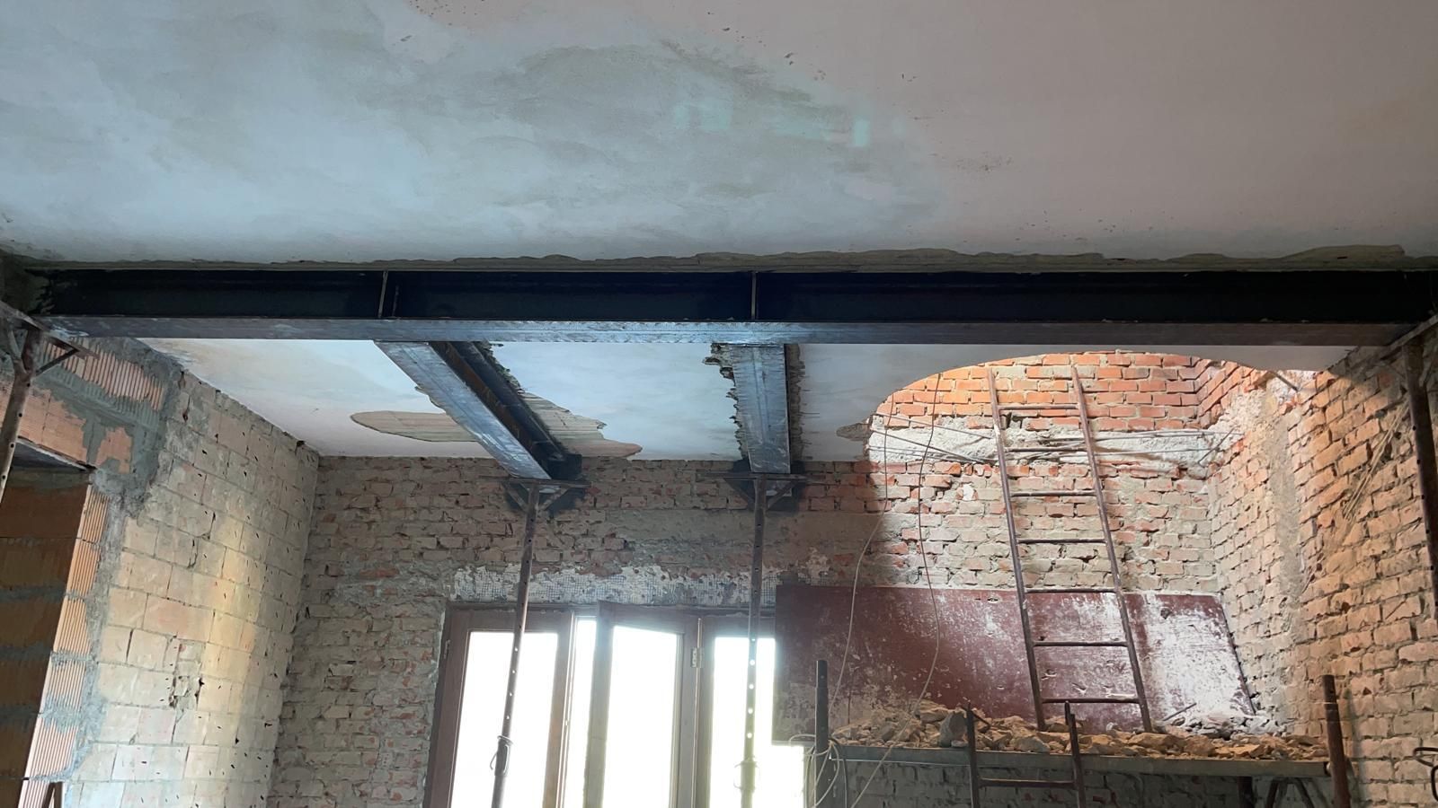 Una stanza con un muro di mattoni e una scala al suo interno.