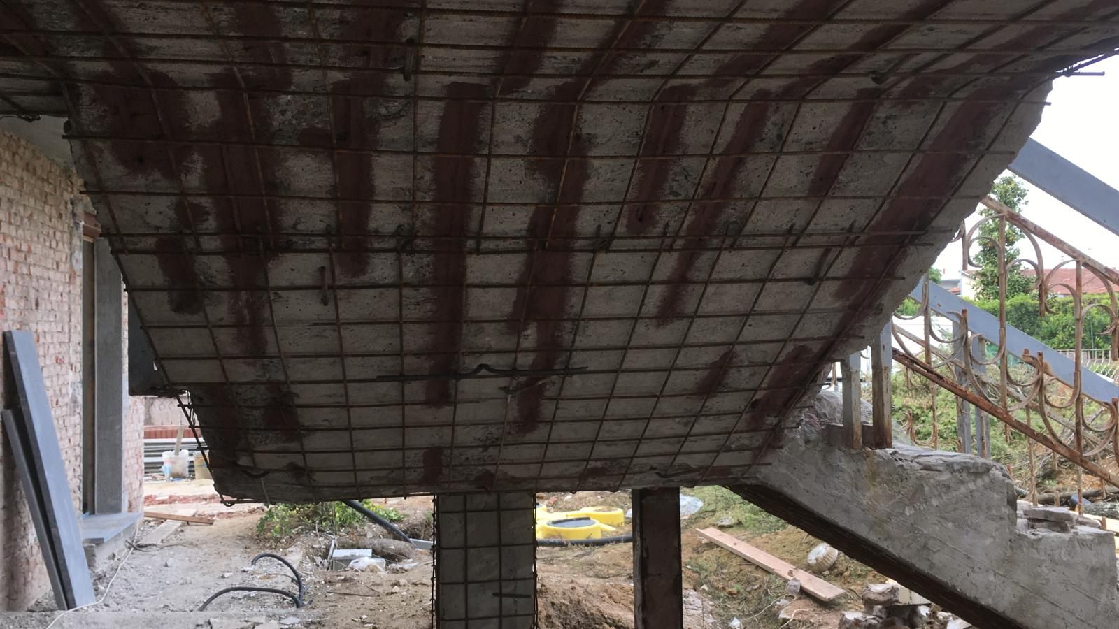 Un edificio in costruzione con soffitto e scale in cemento.