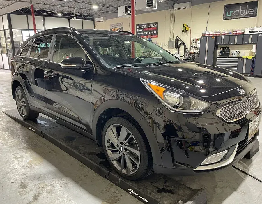 Black car ceramic coated in a garage