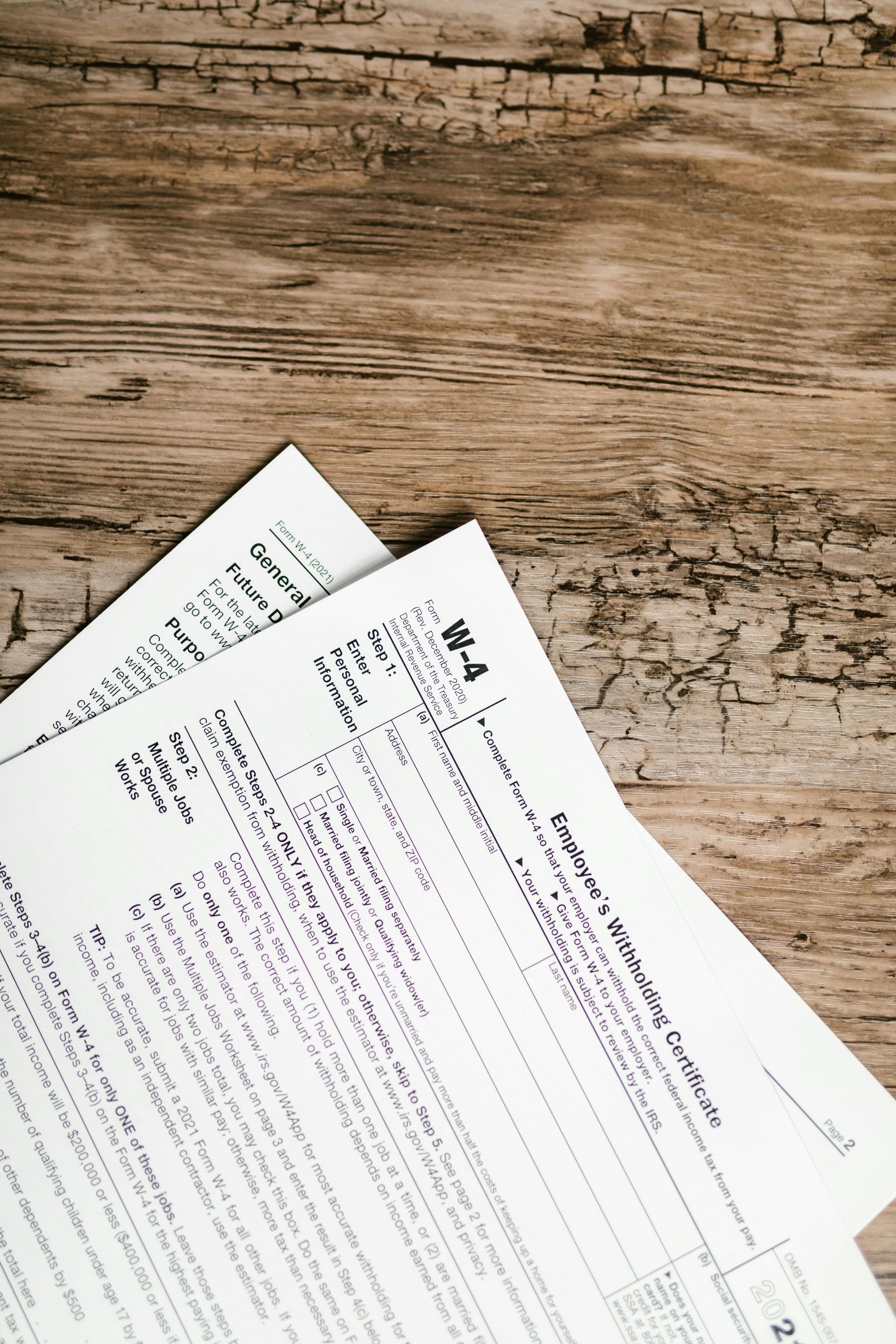 A stack of papers sitting on top of a wooden table.