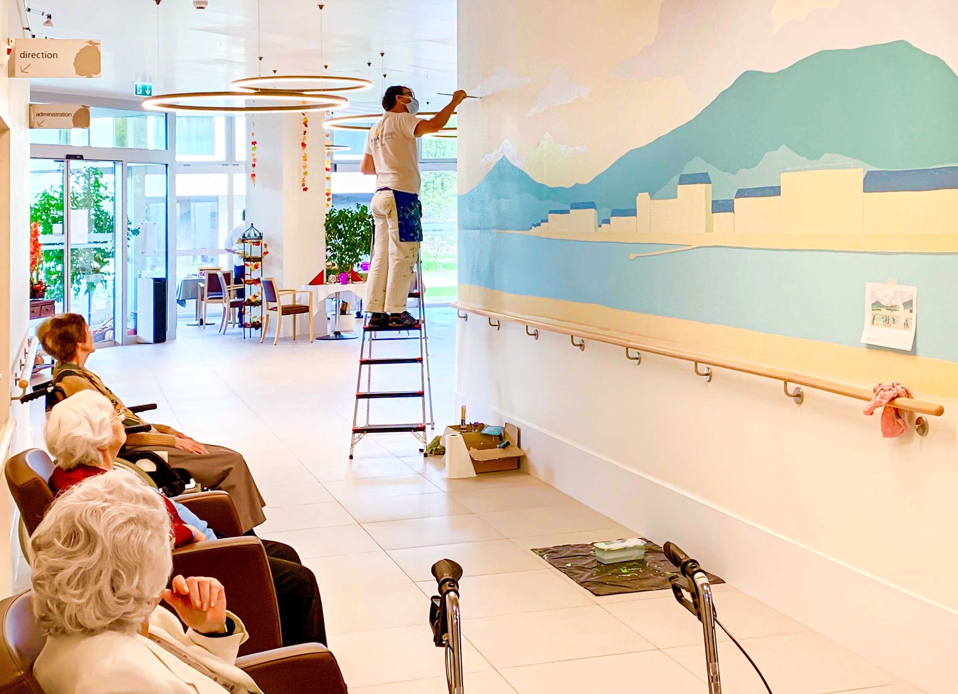 Assisted living hallway murals being painted