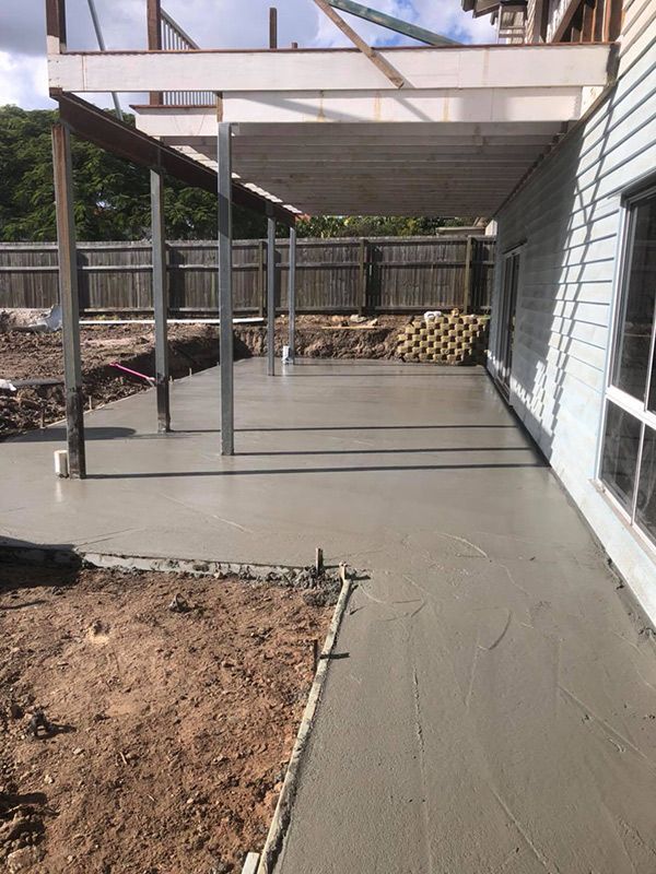 A Concrete Walkway Is Being Built in Front of A House — Polson Construction in Kedron, QLD