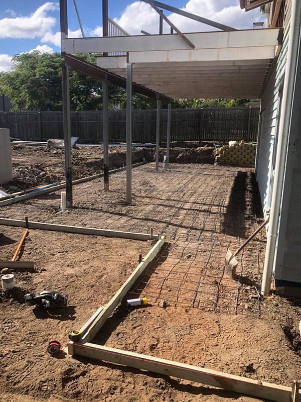 A Patio Is Being Built in The Backyard of A House — Polson Construction in Kedron, QLD