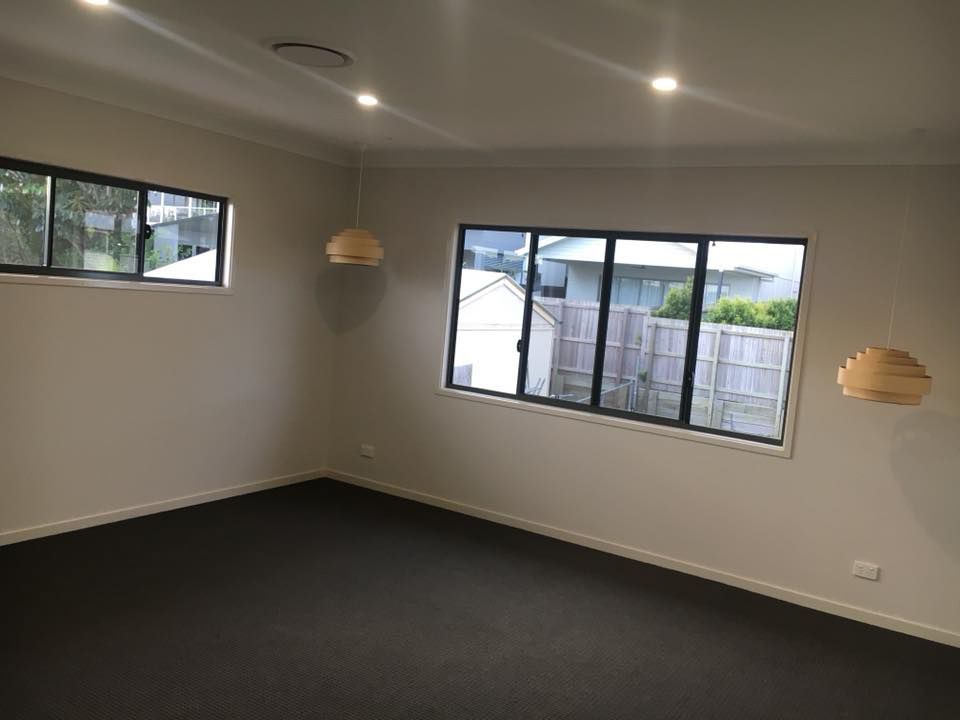 An Empty Room with A Lot of Windows and A Black Carpet — Polson Construction in Kedron, QLD