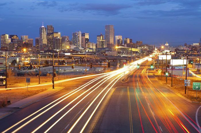A highway with a city in the background at night