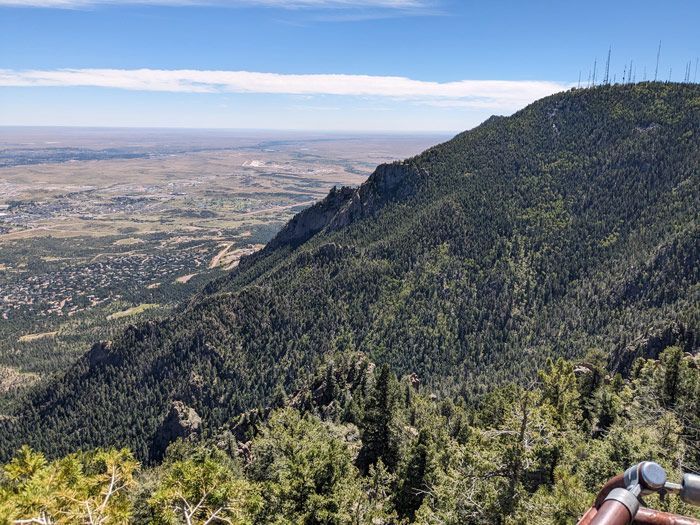 A view of a city from the top of a mountain.