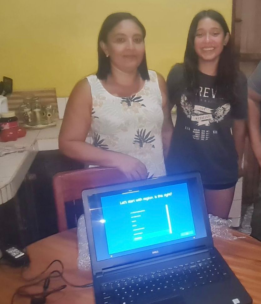 2 Costa Rican sisters with computer for school