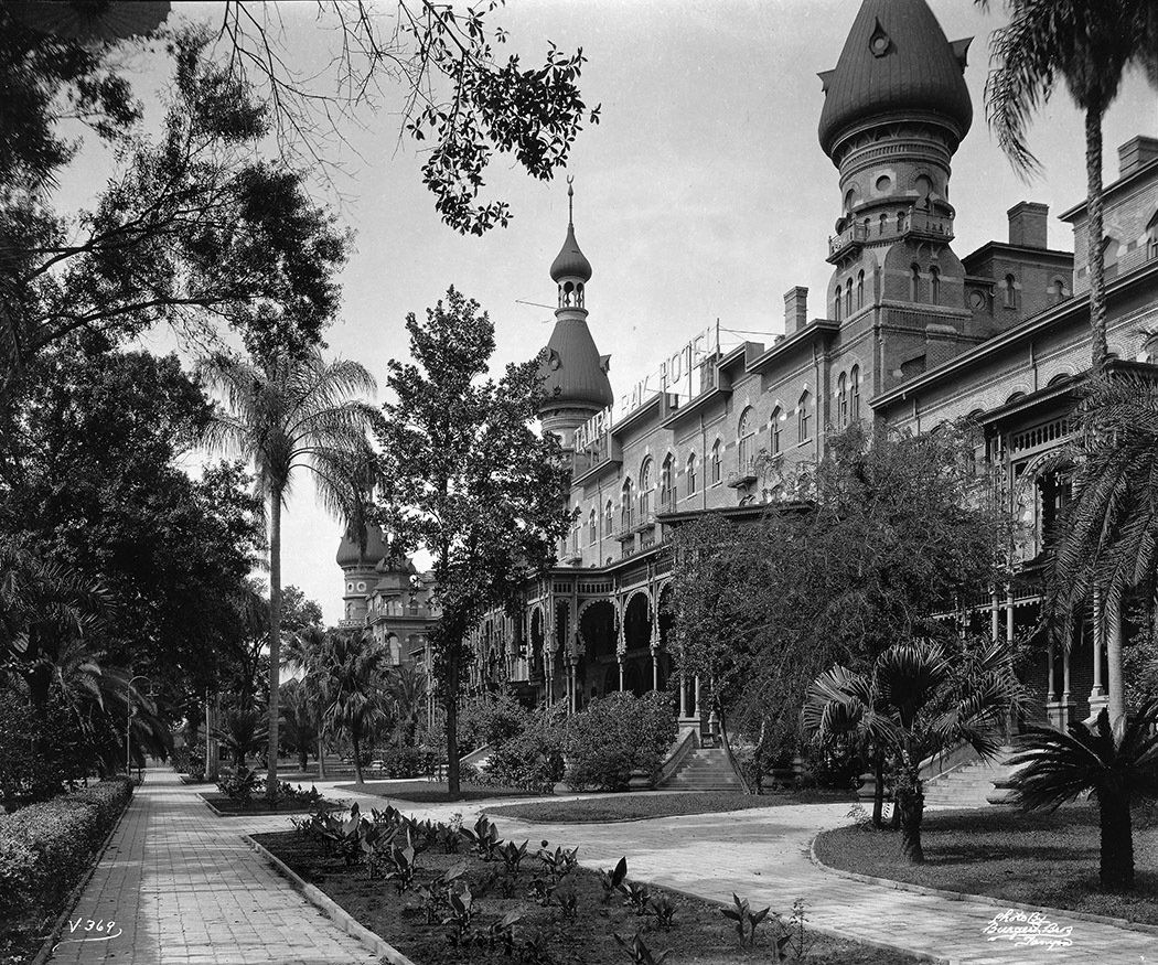 A black and white photo of a castle surrounded by trees