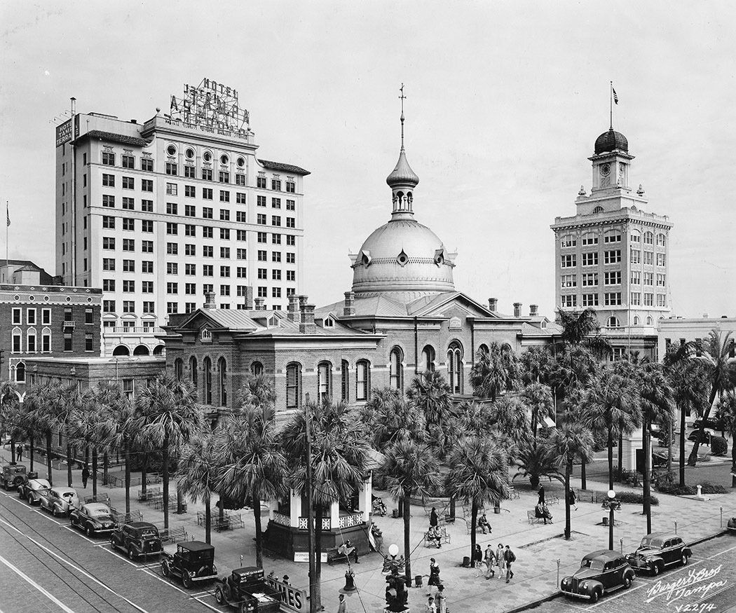 A black and white photo of a large building with a dome on top