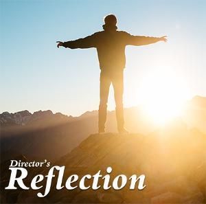 A person standing on a rocky peak with arms outstretched against a bright sunrise, with the text 