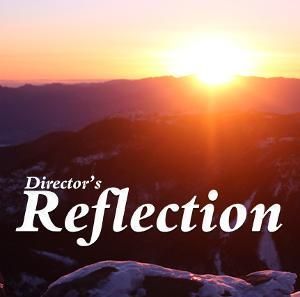 A sunrise over a snowy mountain range with the white text 