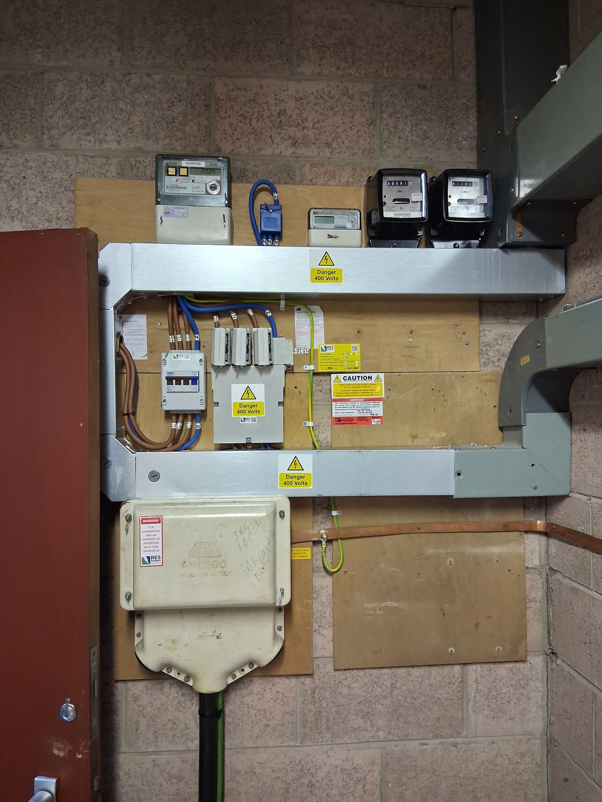 A wall with a bunch of electrical equipment on it