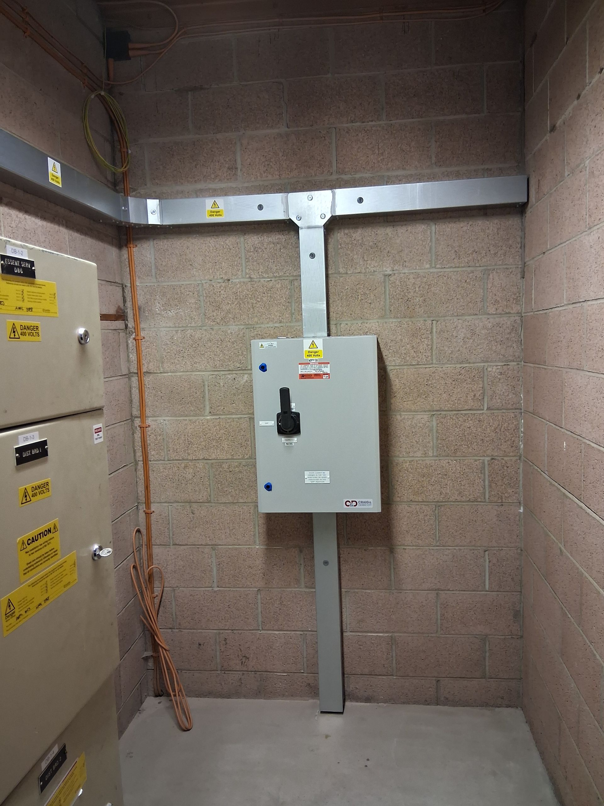 A room with a brick wall and a box on the wall.