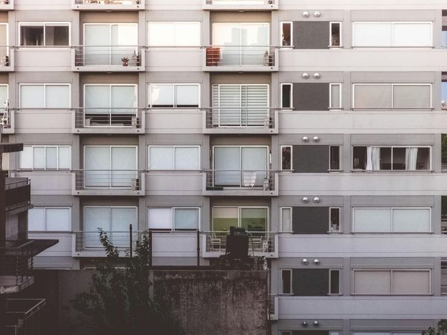 A large apartment building with lots of windows and balconies
