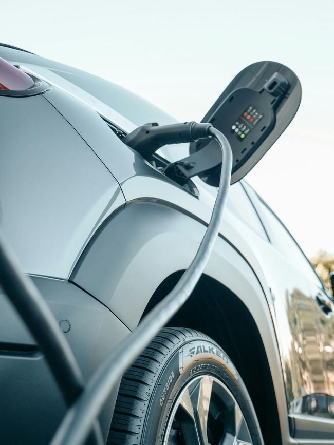 A close up of an electric car being charged