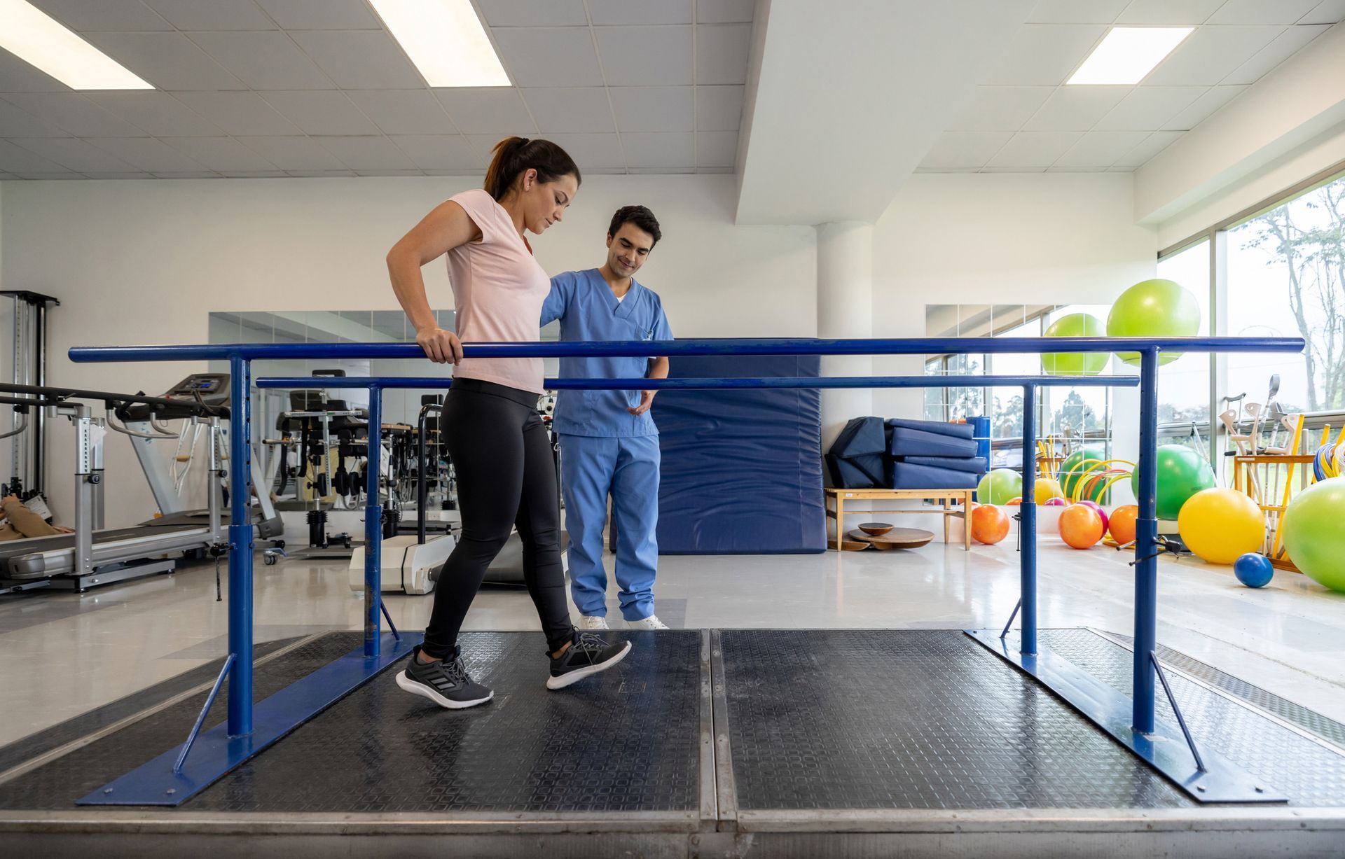Man doing physical therapy exercises using a balance ball.