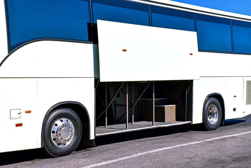A White Bus with The Back Door Open Is Parked on The Side of The Road — G & D Ross Bus Charters In Montville, QLD