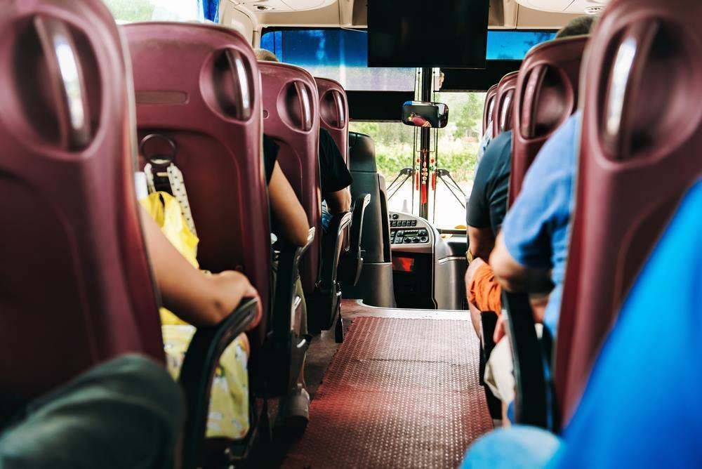 Bus Interior With Burgundy Seats and Passengers Sitting Inside in Queensland