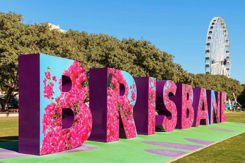 A Large Sign that Says Brisbane with Flowers on It — G & D Ross Bus Charters In Brisbane, QLD