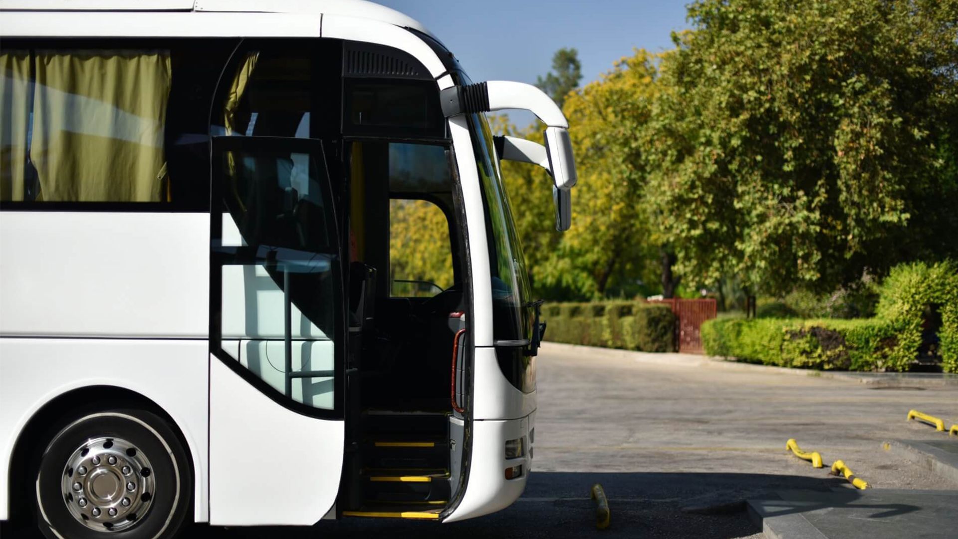 A White Bus Is Parked in A Parking Lot — G & D Ross Bus Charters In Magnolia, QLD