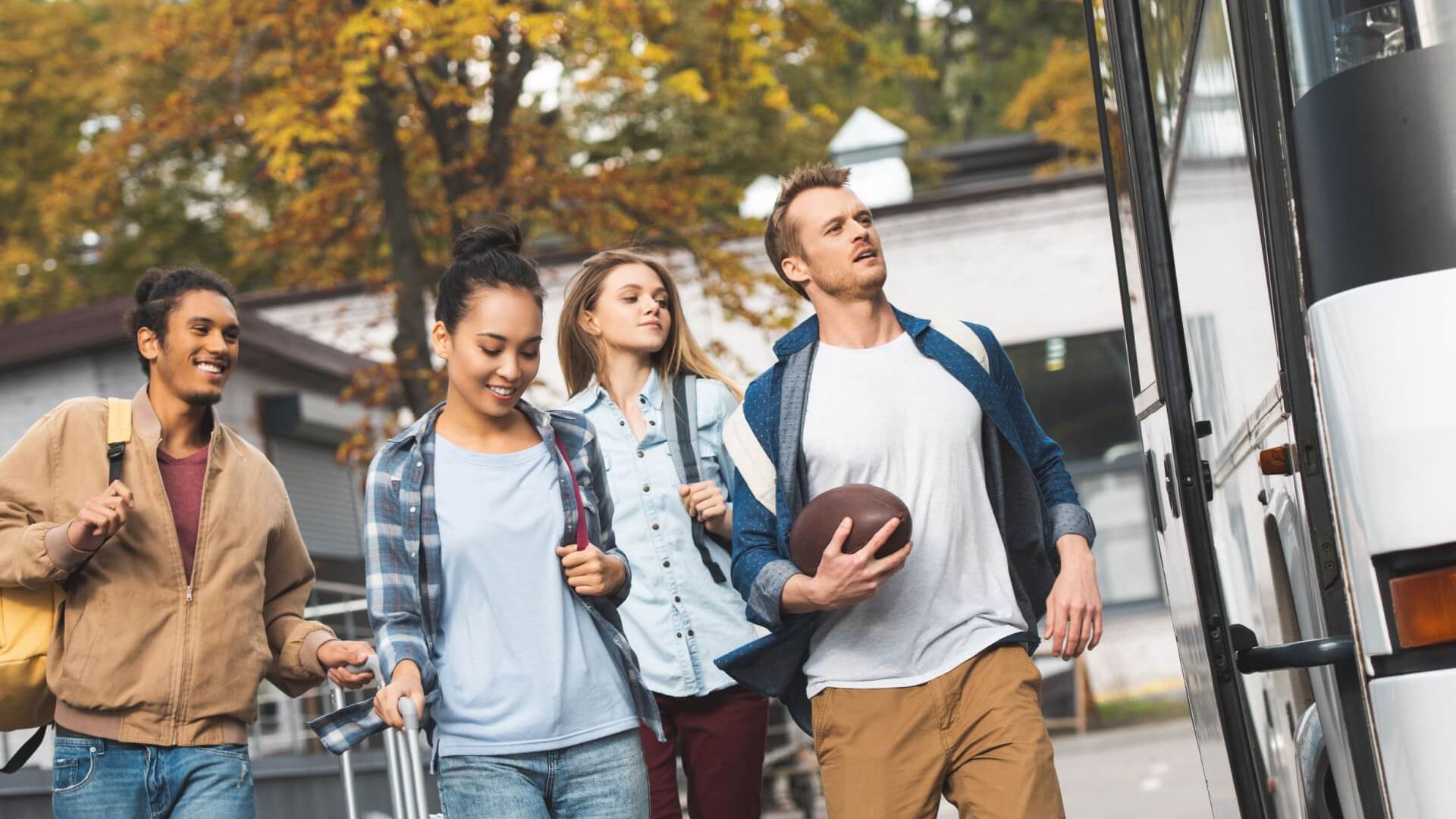 A Group of Young People Are Walking Towards a Bus — G & D Ross Bus Charters In Magnolia, QLD