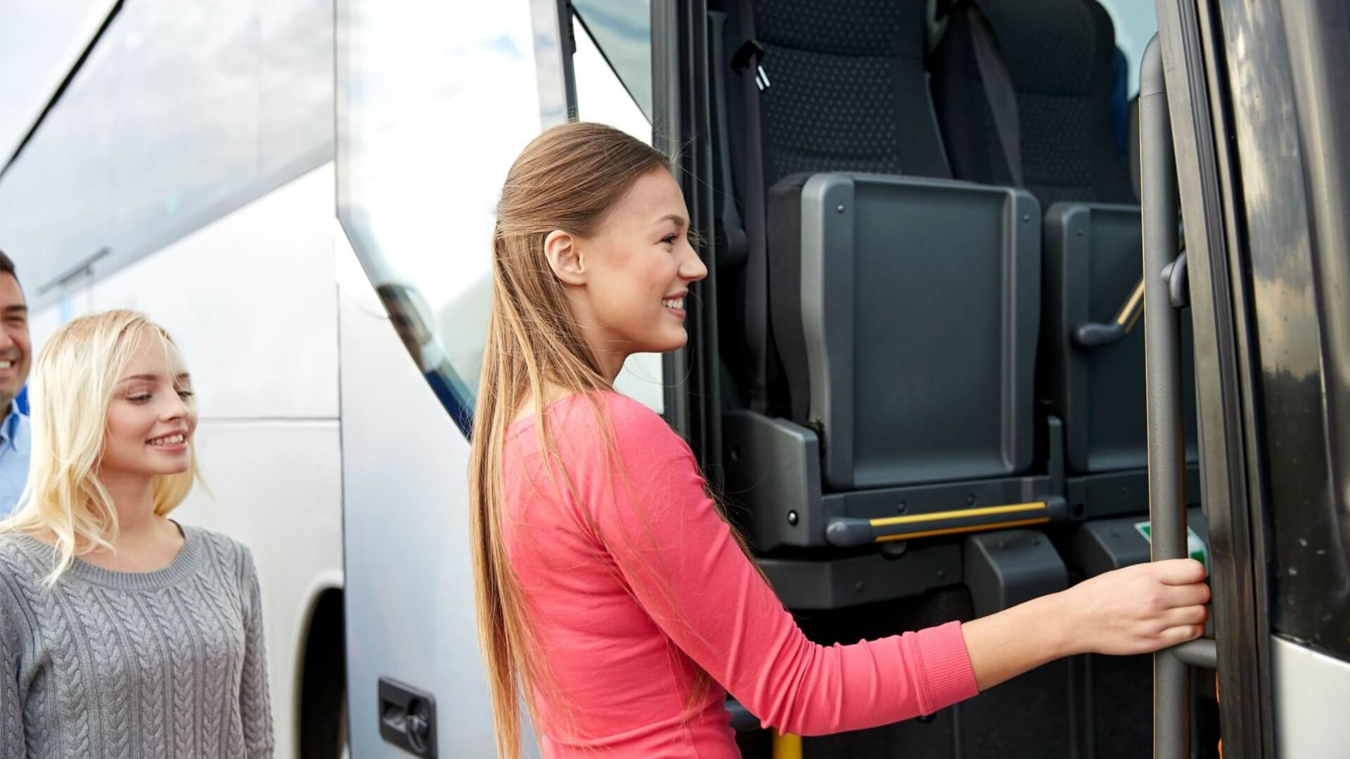 A Woman Is Opening the Door of A Bus — G & D Ross Bus Charters In Magnolia, QLD