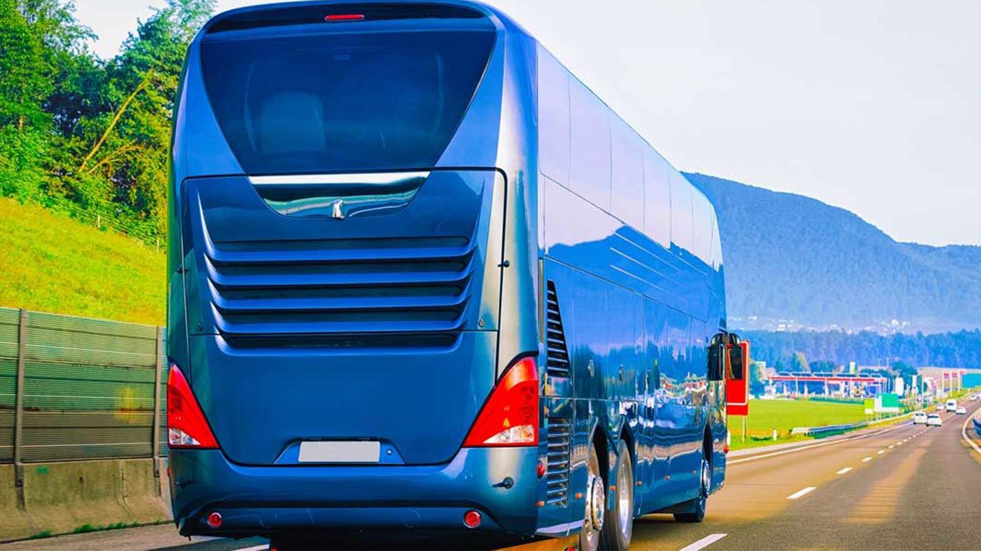 A Blue Bus Is Parked on The Side of A Highway — G & D Ross Bus Charters In Magnolia, QLD