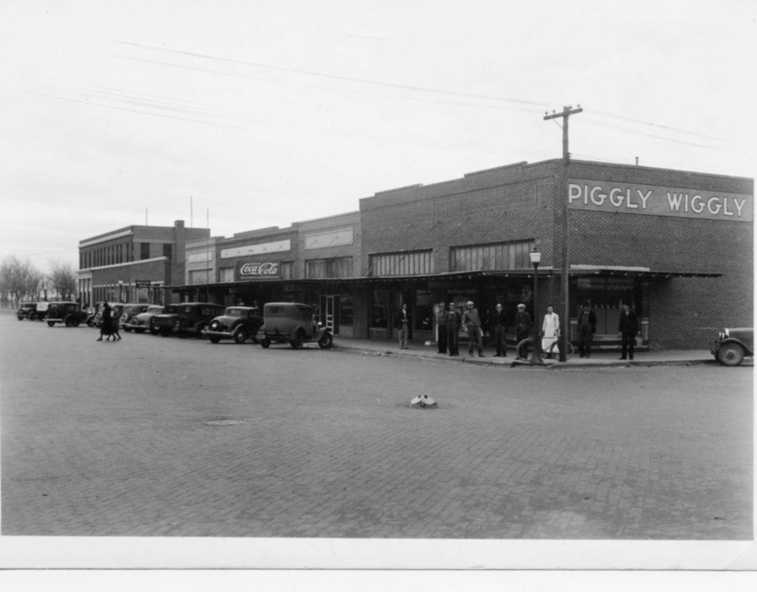 A black and white photo of a store called piggly wiggle