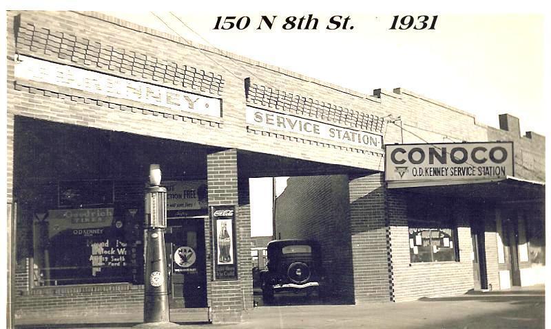 A black and white photo of a service station in 1931