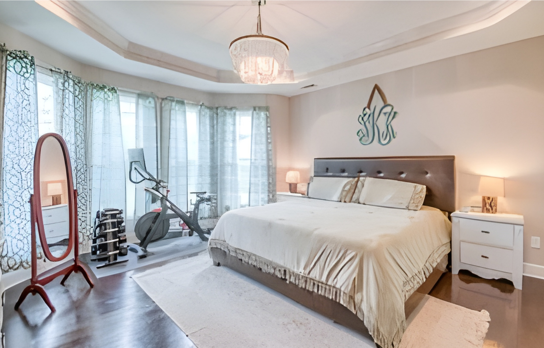 Modern two-story house with a concrete driveway, gray siding, and a two-car garage surrounded by trees.