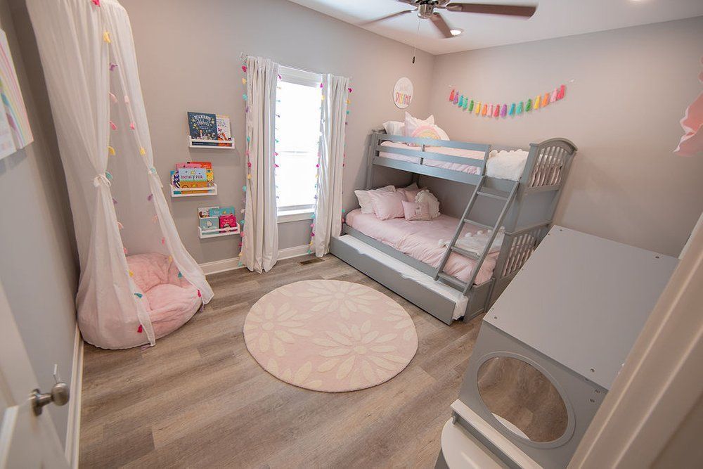 A bedroom with a bunk bed and a slide.