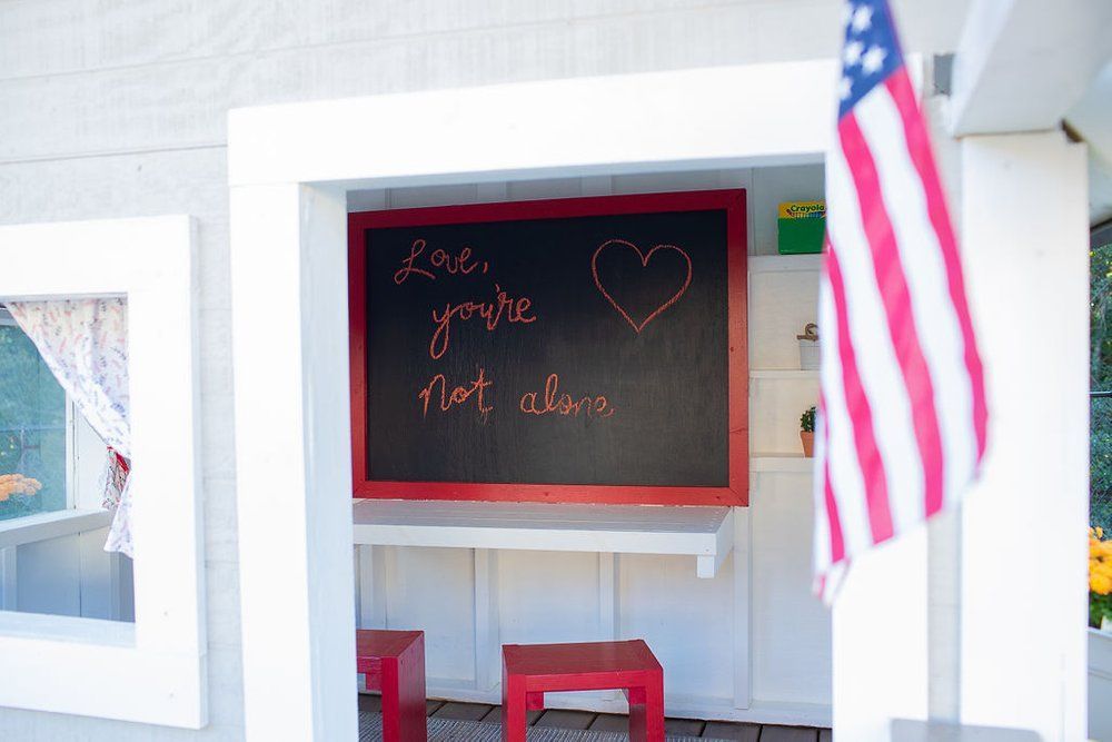 A chalkboard with a heart drawn on it says 
