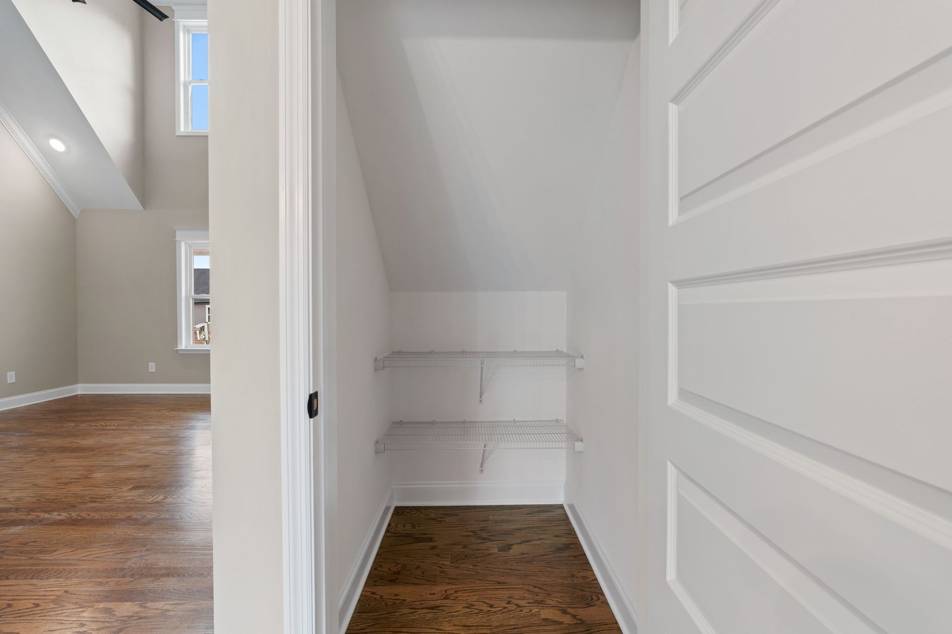 A small closet with a staircase in a house.