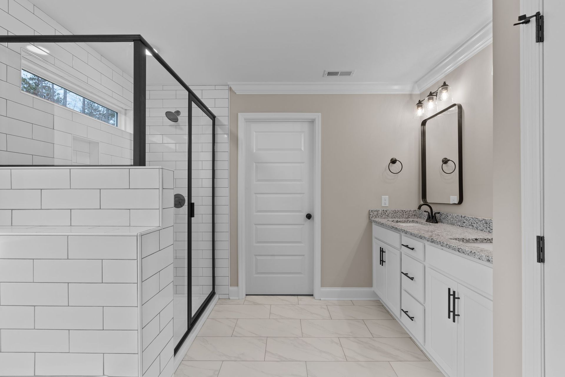 A bathroom with a walk in shower , sink , and mirror.