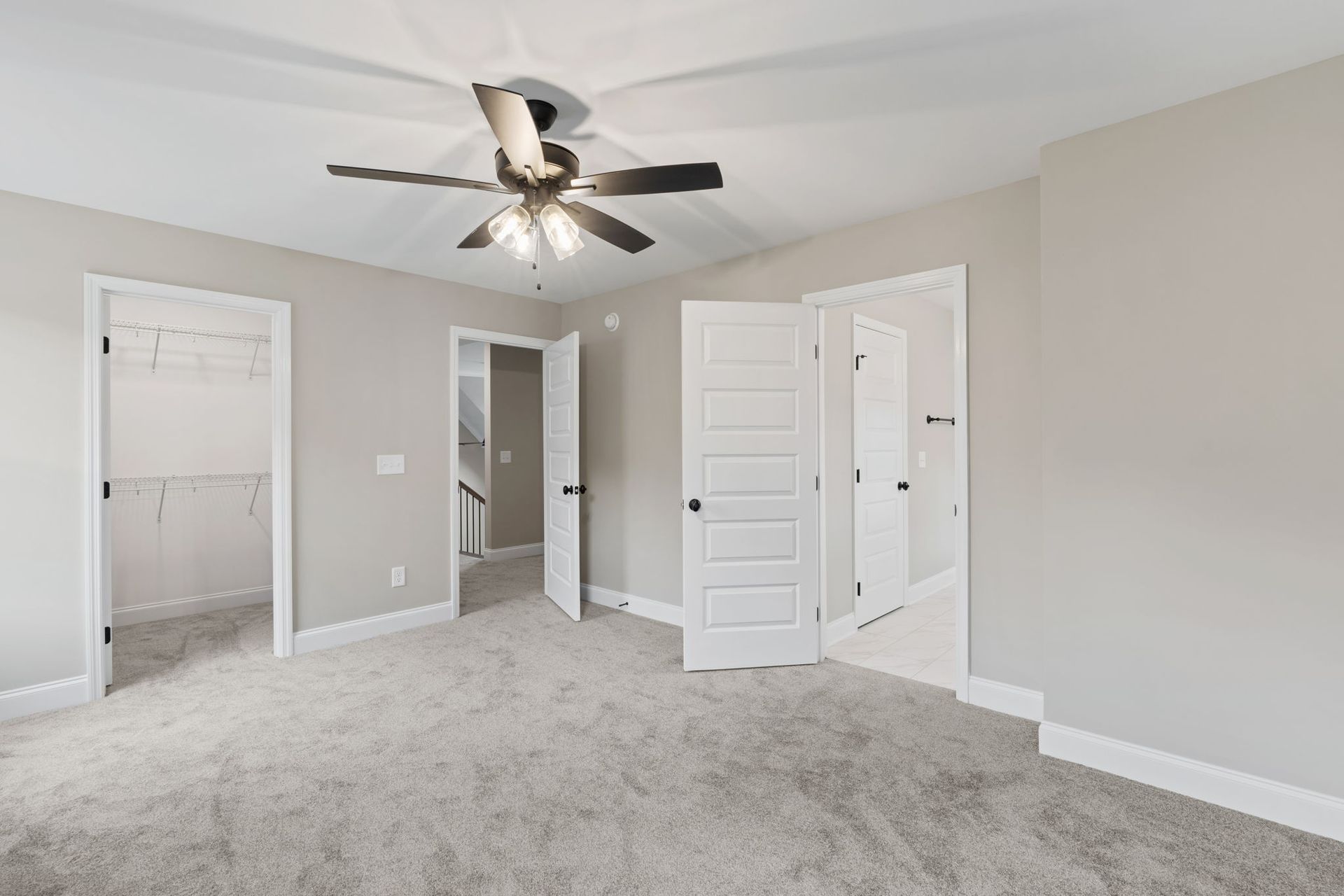 There is a ceiling fan in the middle of the room.