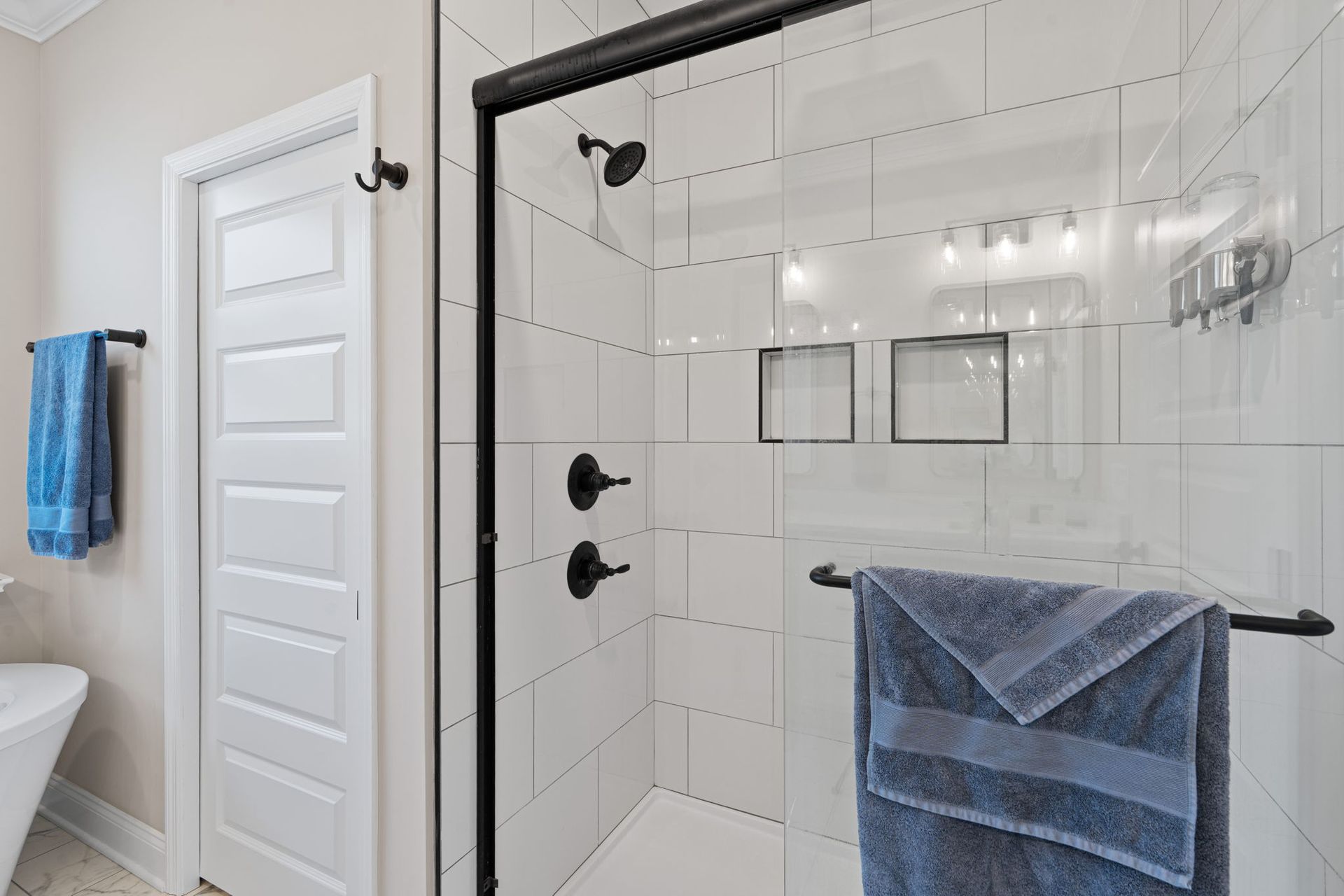 A bathroom with a walk in shower and a bathtub.