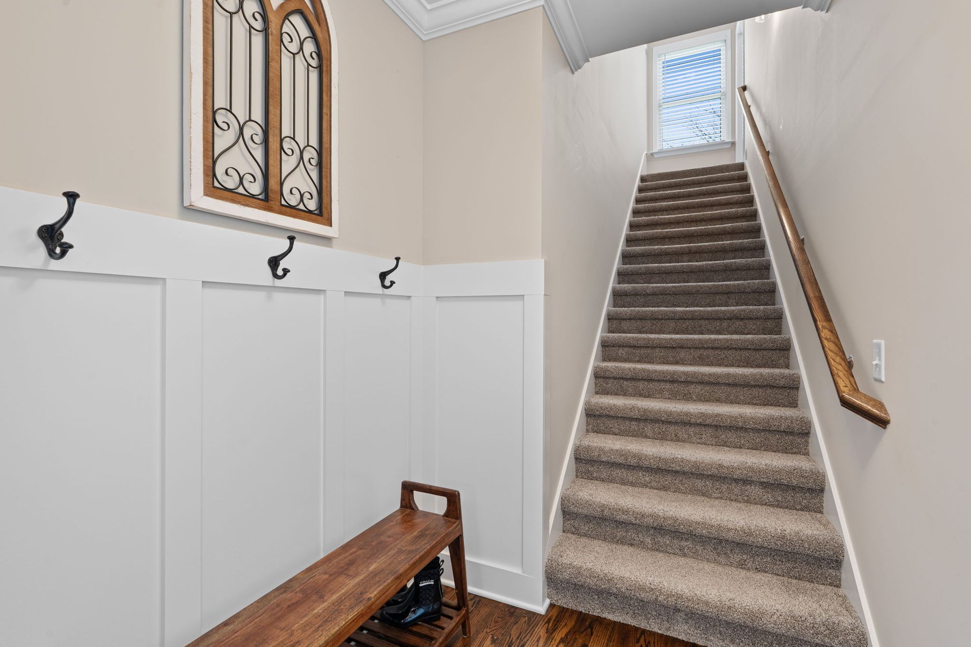 A hallway with stairs leading up to the second floor of a house.