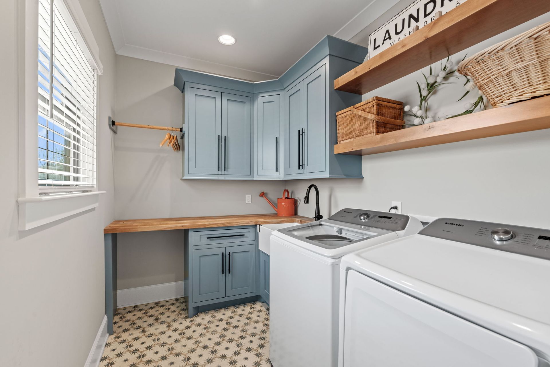 A laundry room with a washer and dryer and a sink.