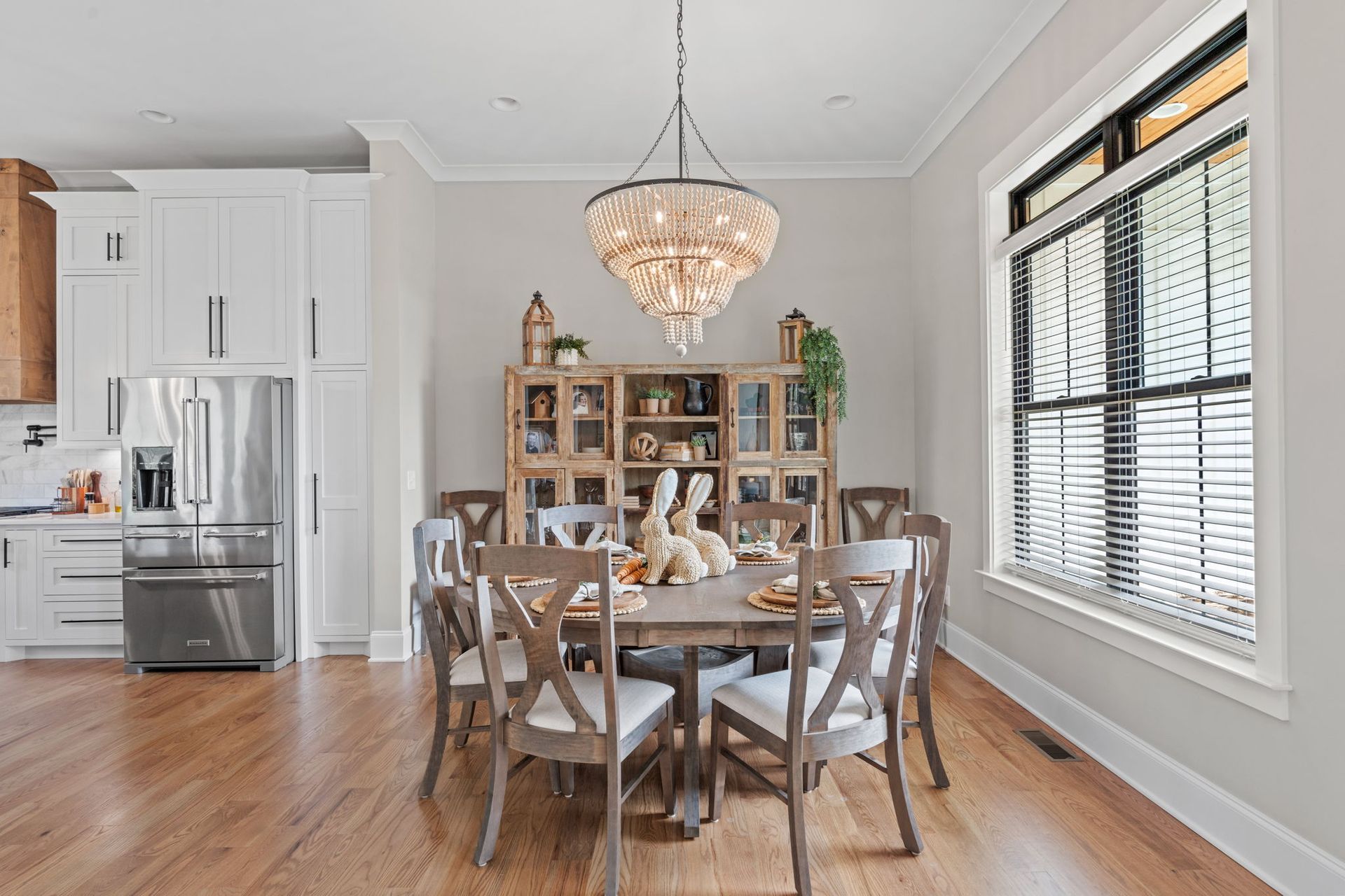 A dining room with a table and chairs and a chandelier.