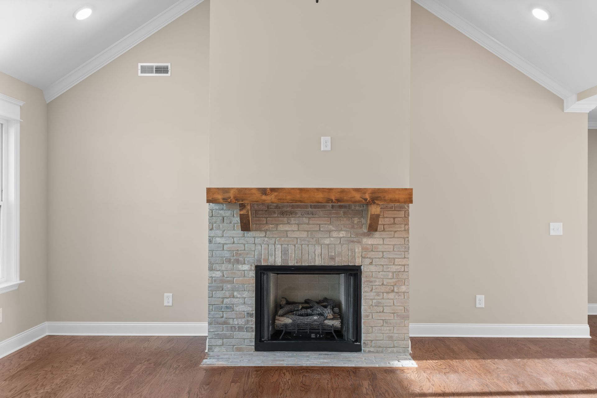 There is a fireplace in the middle of the living room.